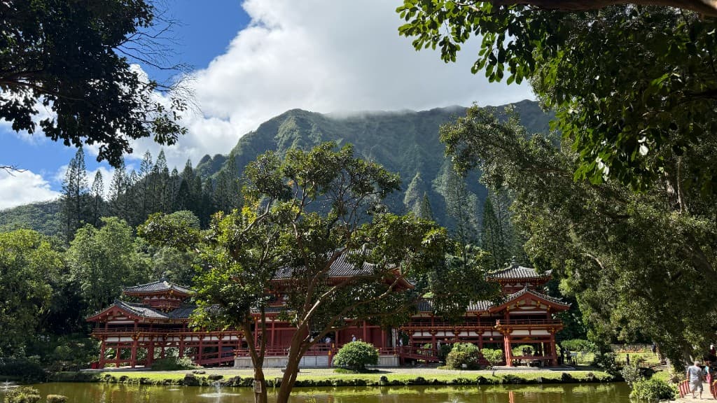 Byodo-In Temple at the base of a green mountain on Oahu