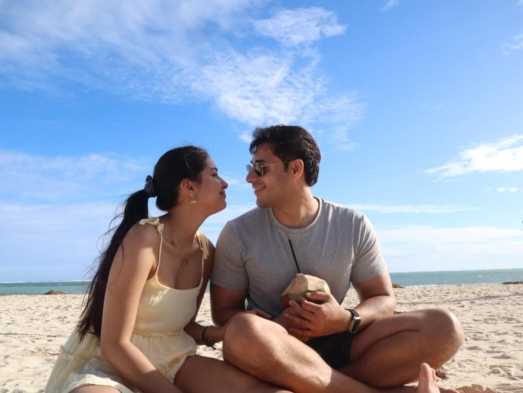 Aswin and Nicole sharing a moment on the beach